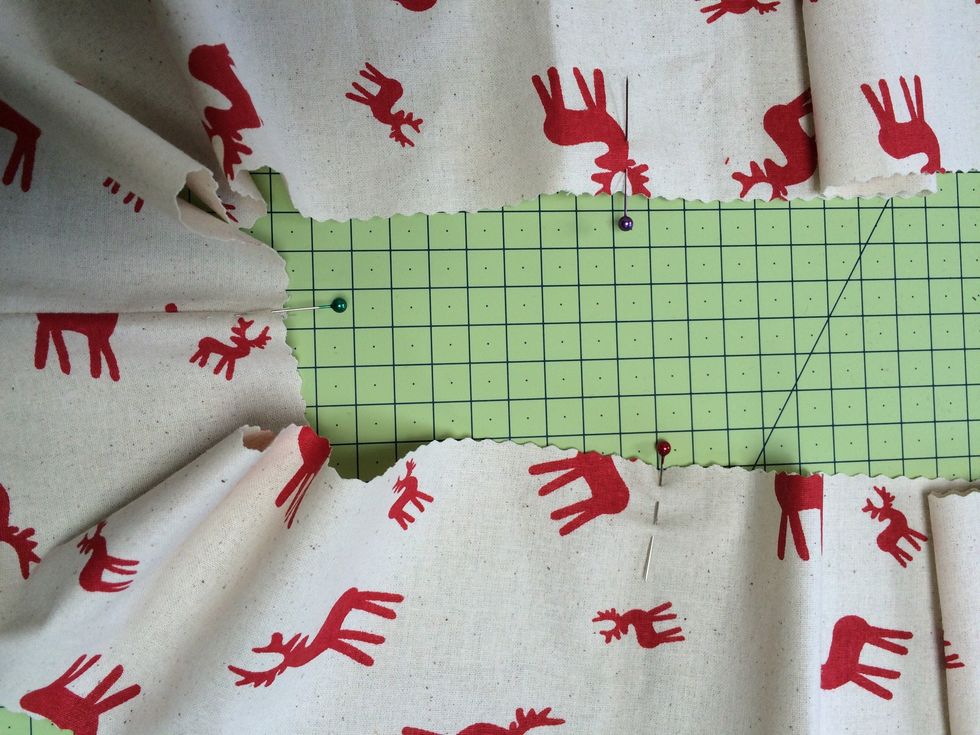 Fold each strip in half and half again . Mark each fold with a pin