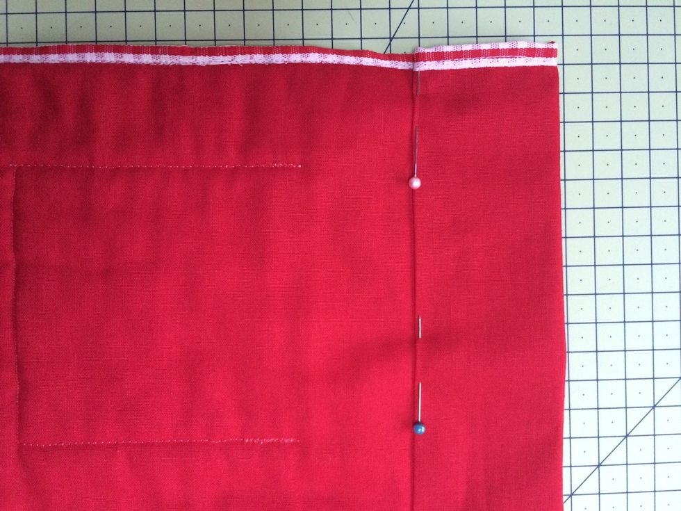 Fold flaps at top and the bottom to the back ,pin and then sew in place forming openings for cafe rods