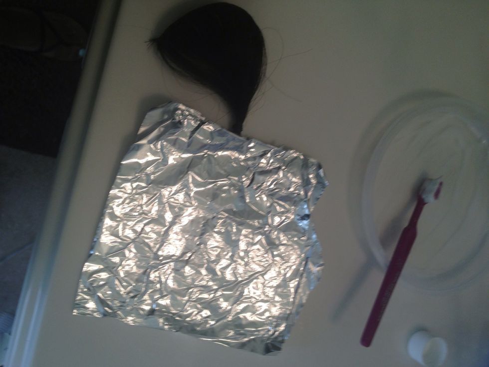 Fold foil over the hair for processing.