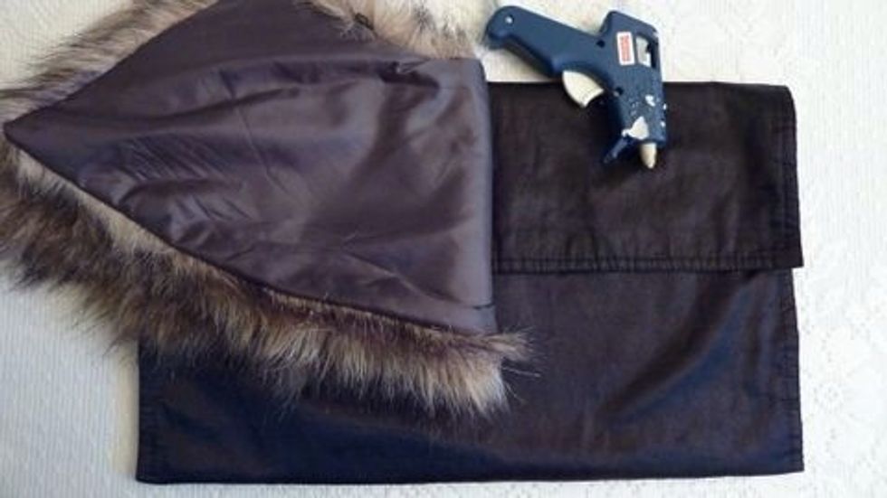 Fold giant placemat now veryically making your clutch size if choice. Glue edges together leaving the top flap open. Next I glued the Fur collar to the front.