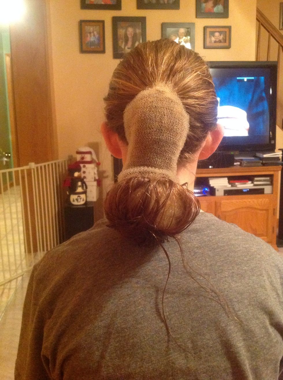 Fold hair into bottom of "Bun Ease" and roll up.