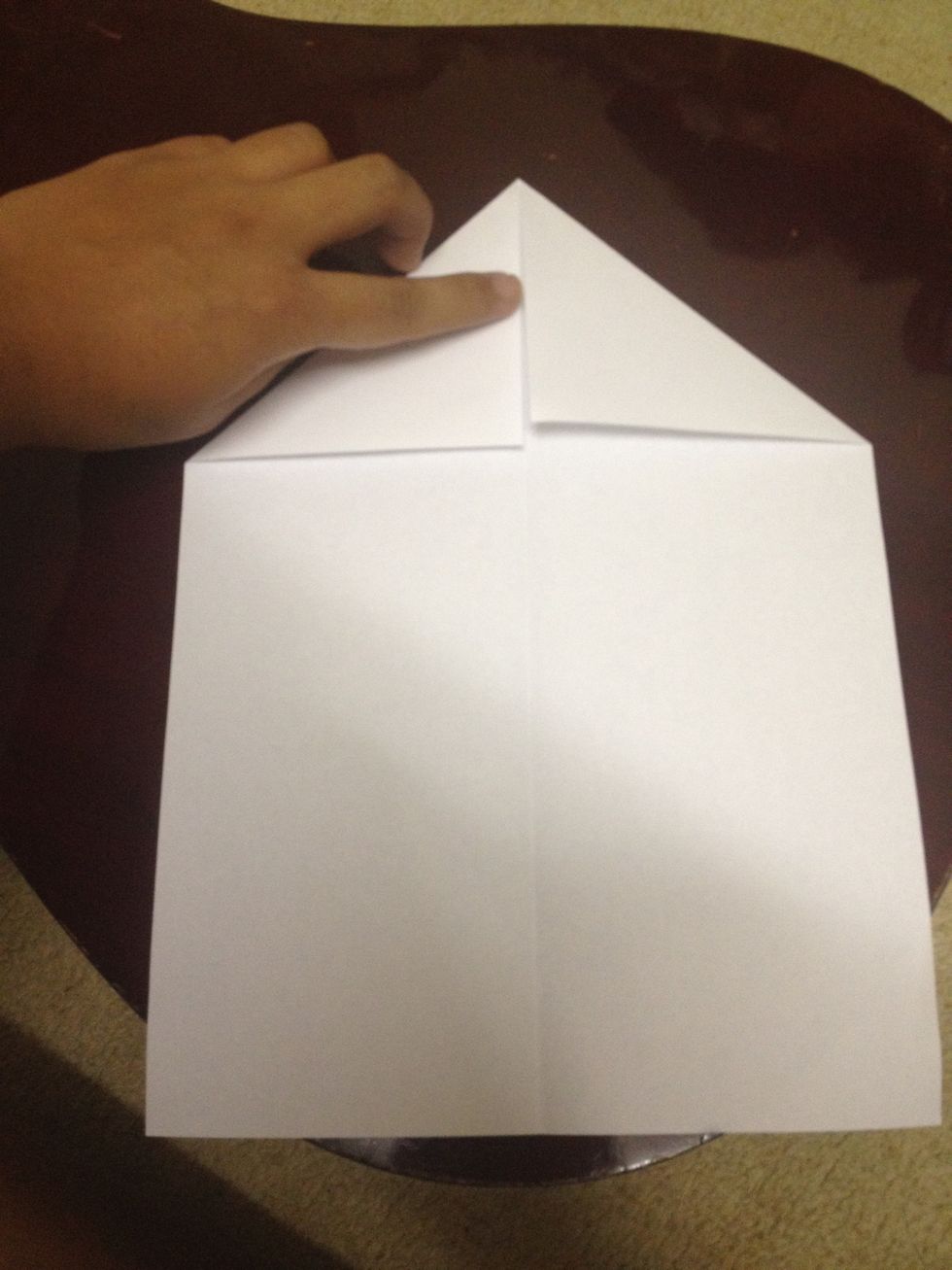 Fold in both sides of paper like so, to create a triangle shape. Fold them evenly.