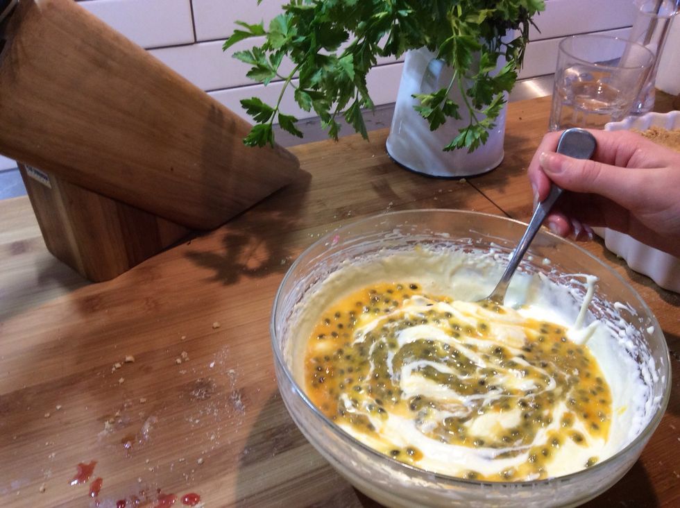Fold in four of the five passion fruits into the mix.