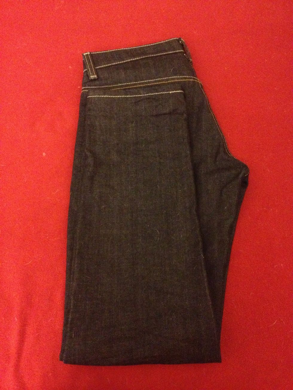 Fold in half again bringing the leg opening to the double stitching on the back of the jean