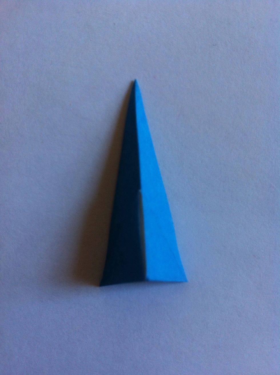 Fold in half as shown. It's not noticeable here, but that bottom triangle pops open a bit down the center crease revealing white & two pockets...
