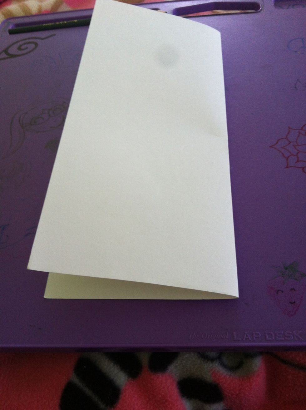 Fold in half. Btw: I'm using lightweight drawing paper, but computer paper works just as well.