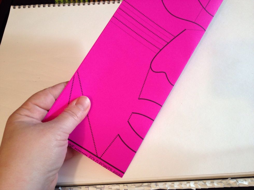 Fold in half, design on the outside.