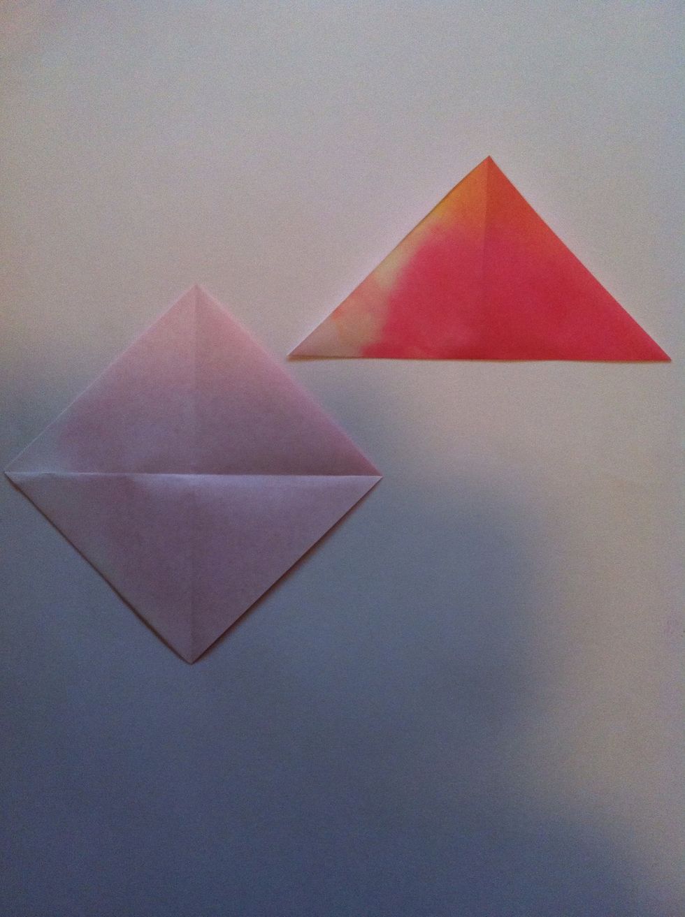 Fold in half diagonally other direction.