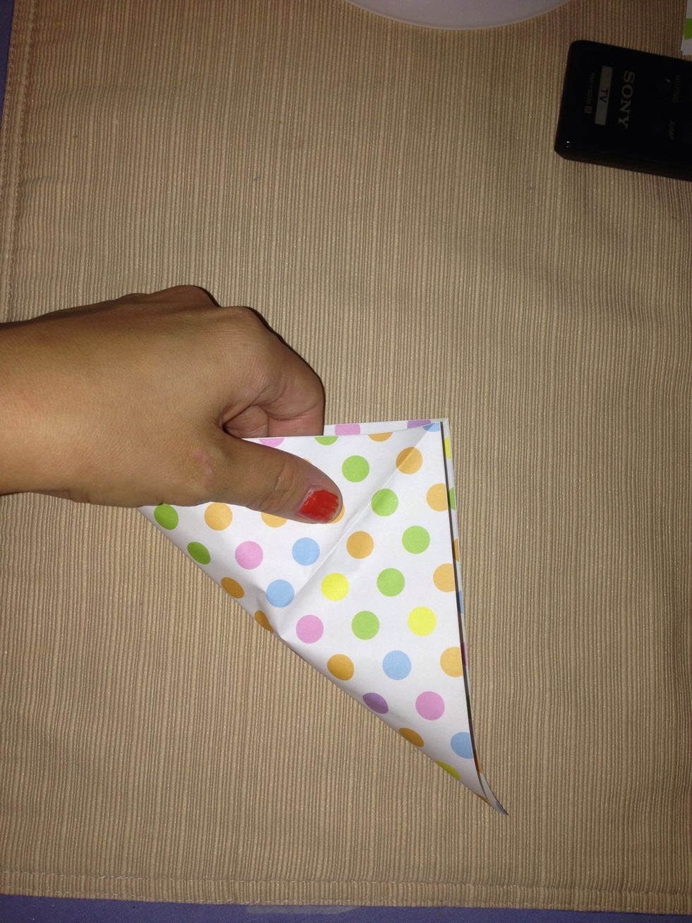 Fold in half diagonally. Unfold. Then repeat with the remaining corners. Unfold.