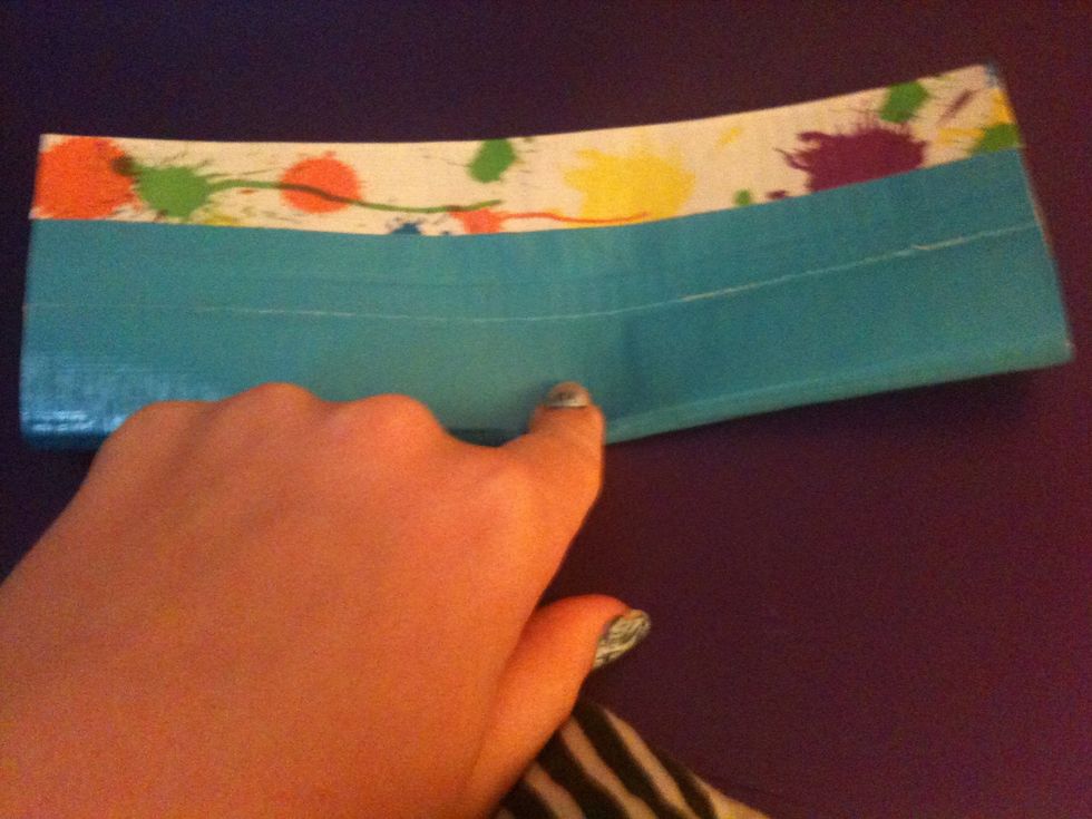 Fold in half longways.