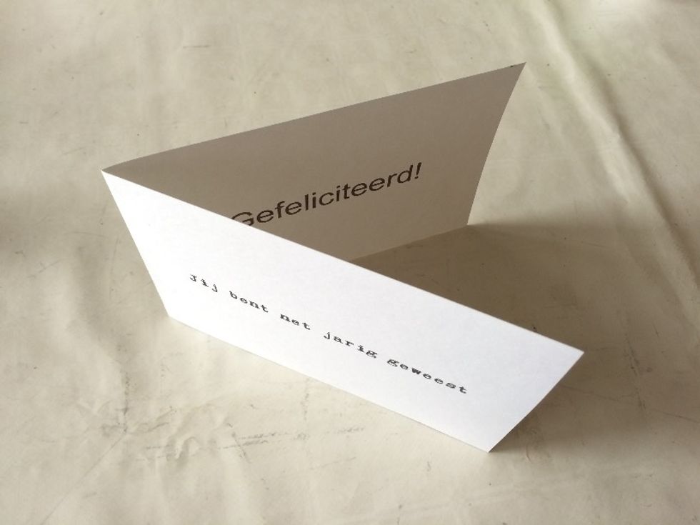 Fold in half on the 29.7 cm (11.7\u2033) side. Make sure your front-side text actually ends up on the front when you fold.