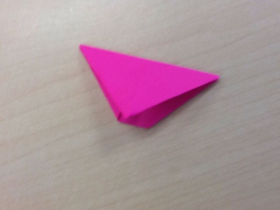 Fold in half, resulting in a triangle. Repeat steps 1-5 seven more times.