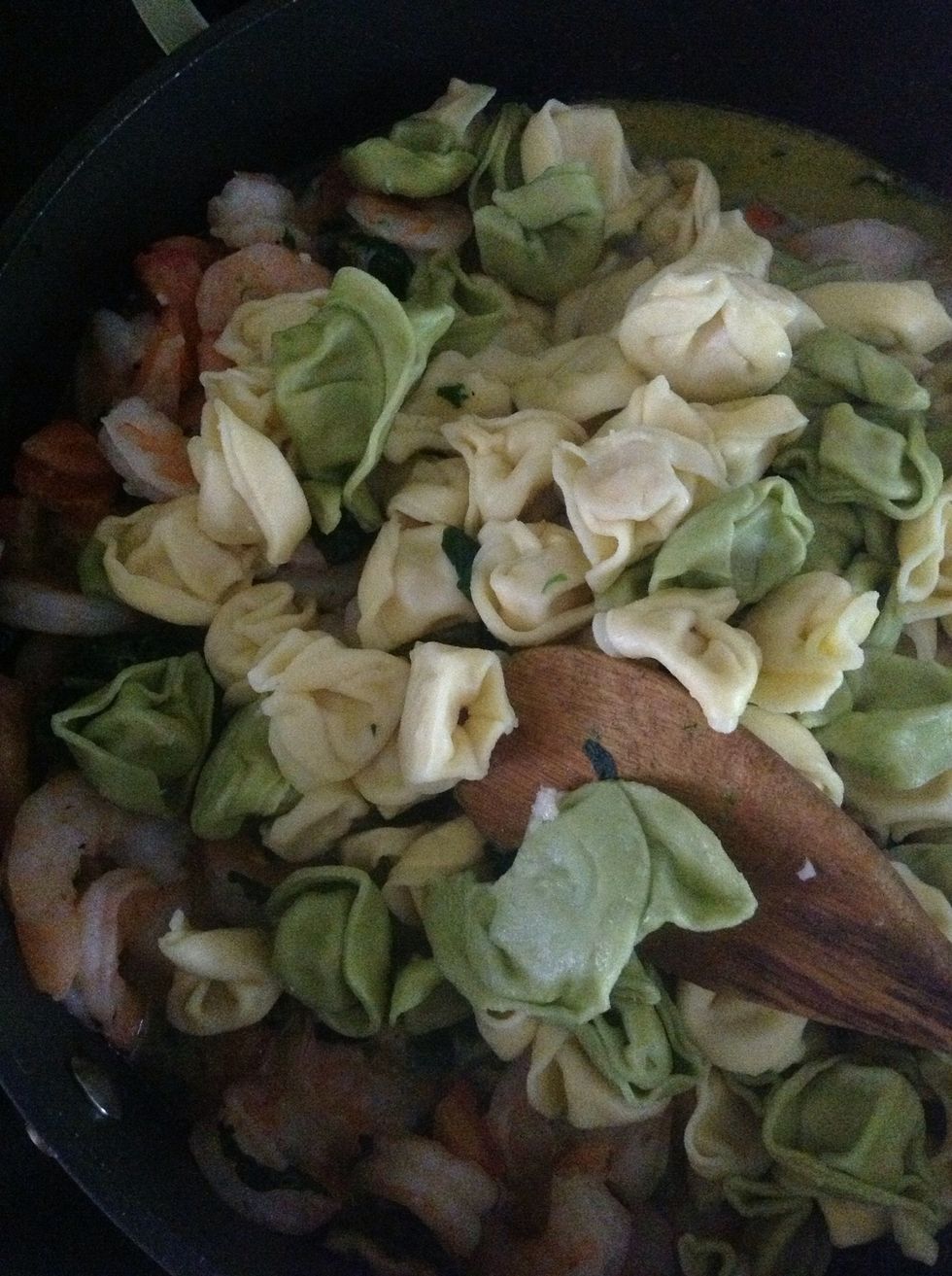 Fold in pasta once tomato is warmed and spinach is thawed.