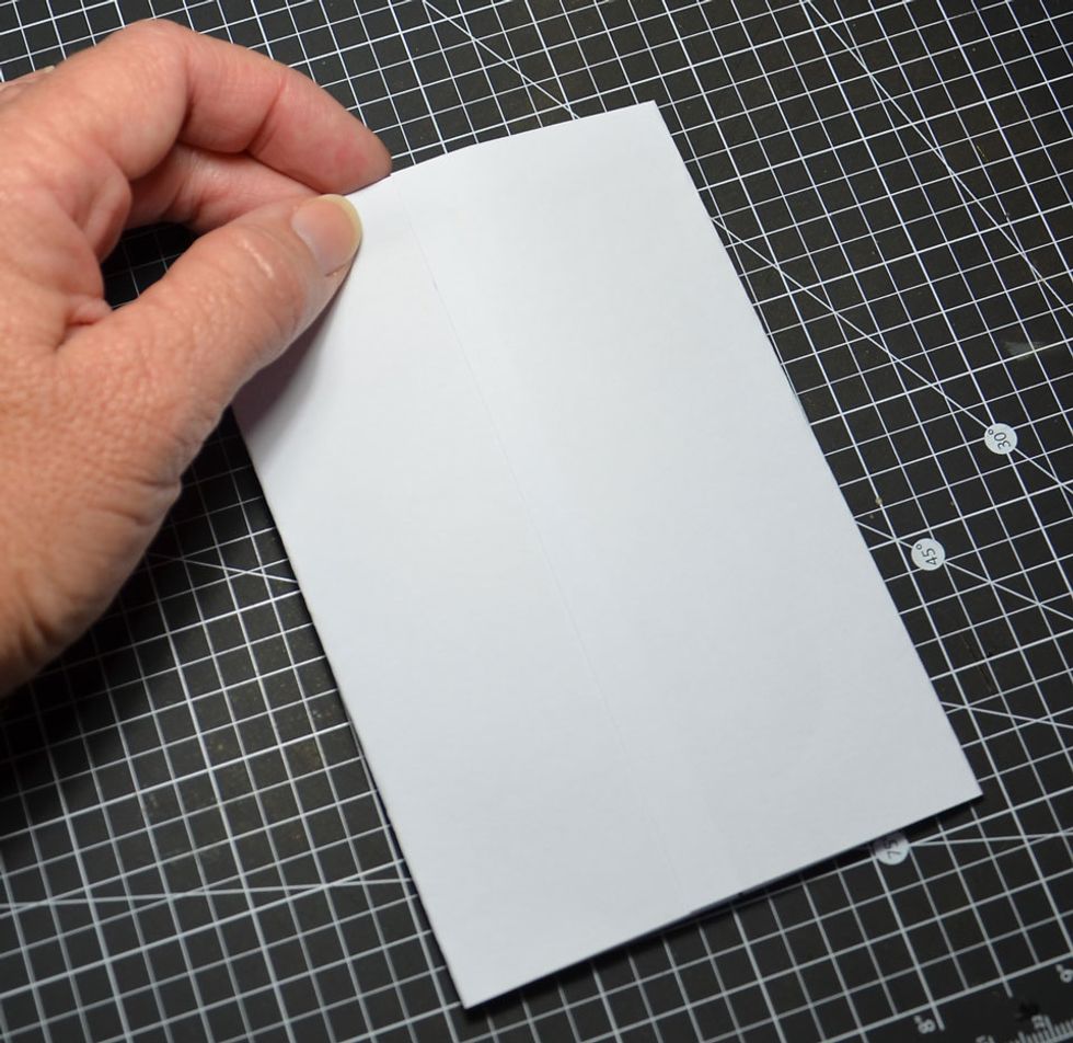 Fold in sides and glue down as shown. Be sure to lip over the top fold for a seamless edge.