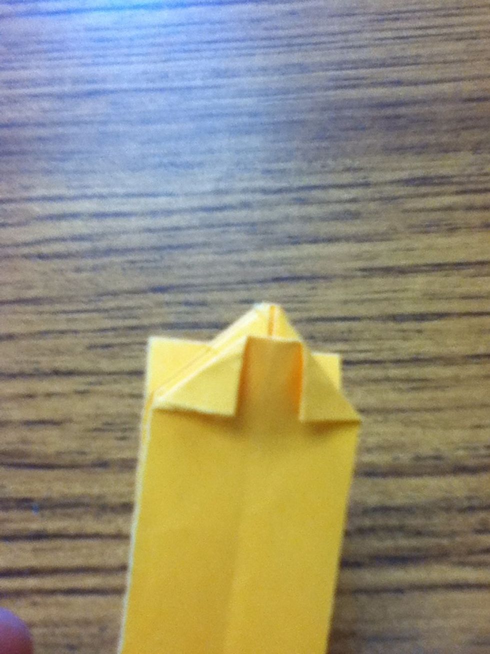 Fold in the corners flush with the triangle's outer edge