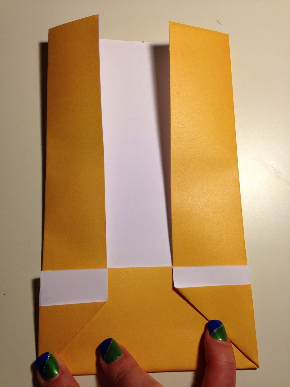 Fold in the flaps to make another crease. This will help in the next few steps. Advance to the next picture to see another image.