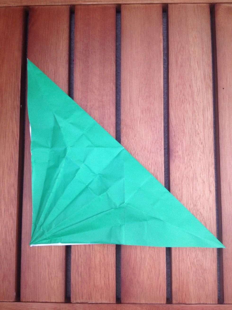 Fold it in half diagonally to make a triangle. I flipped mine over so the white side was face up before I folded it.