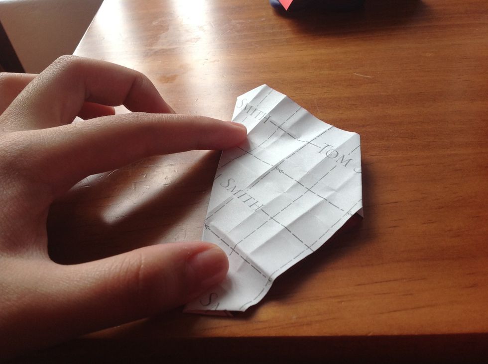 Fold it in half horizontally. Then do the same vertically.