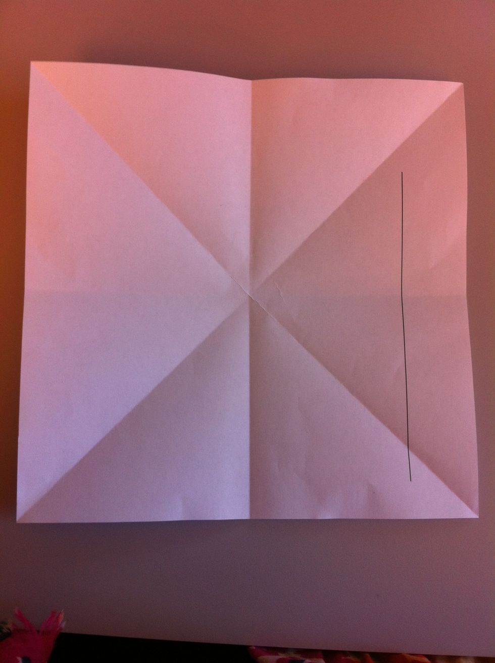 Fold it on half so you end up with a cross shape.
