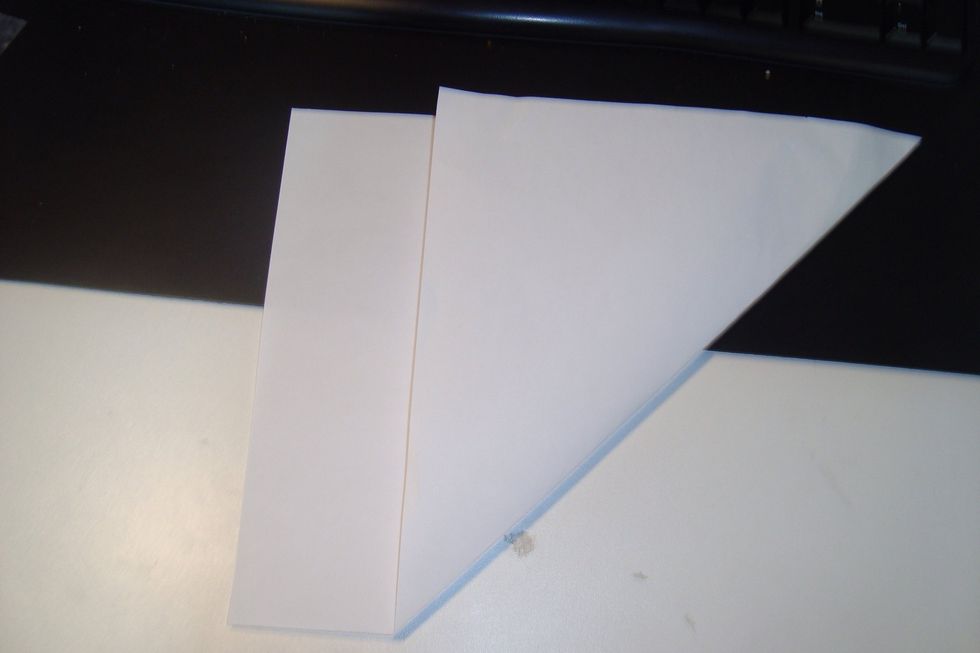 Fold it over so it creates a square shape.