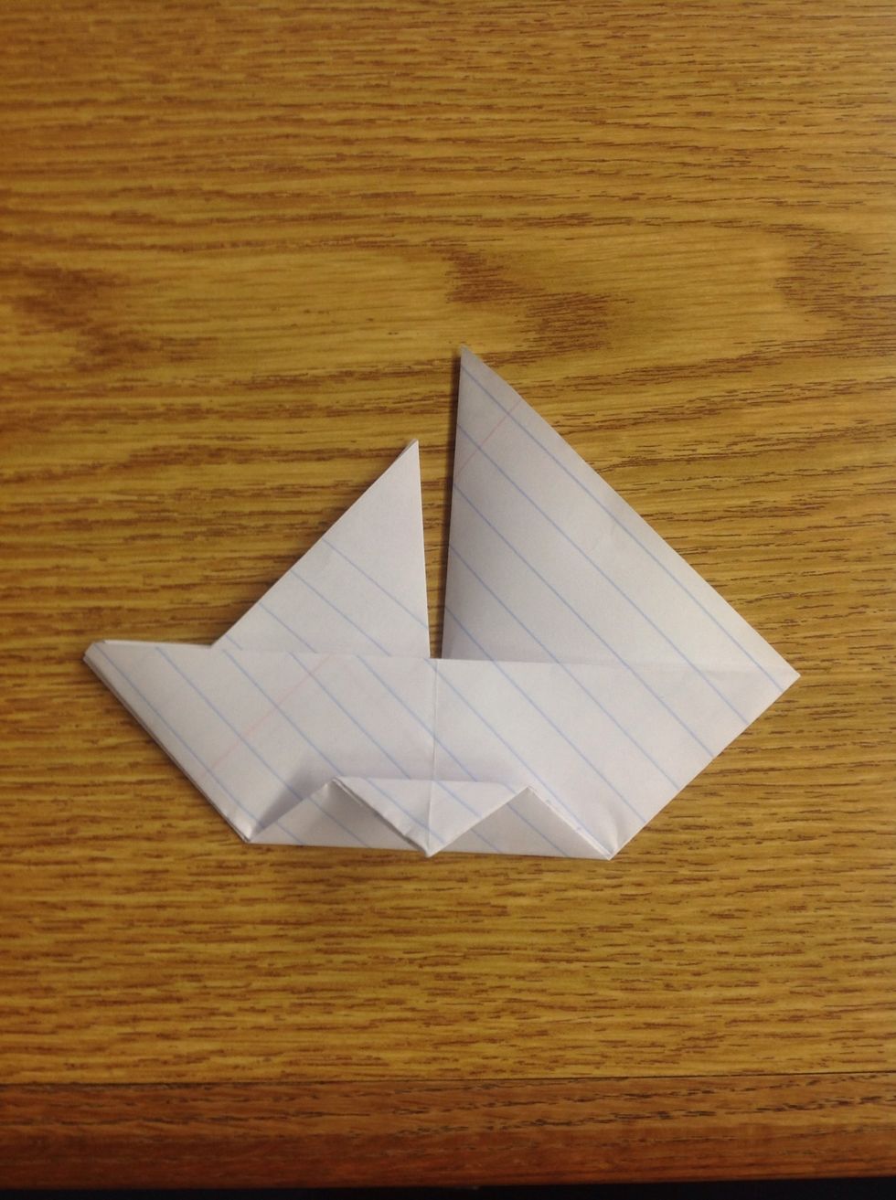 Fold it partially down, but don't crease it, as it'll be the stand for the sailboat.