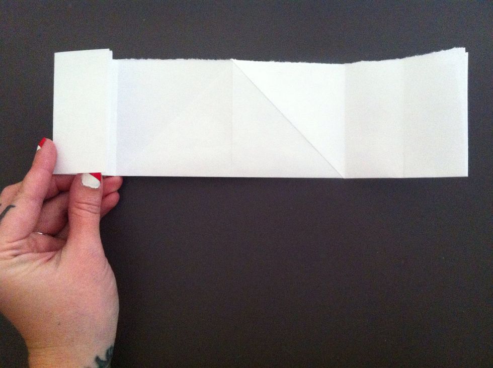 Fold left edge to the first crease on left side (the crease made from previous fold). Repeat on right side & unfold (right only).