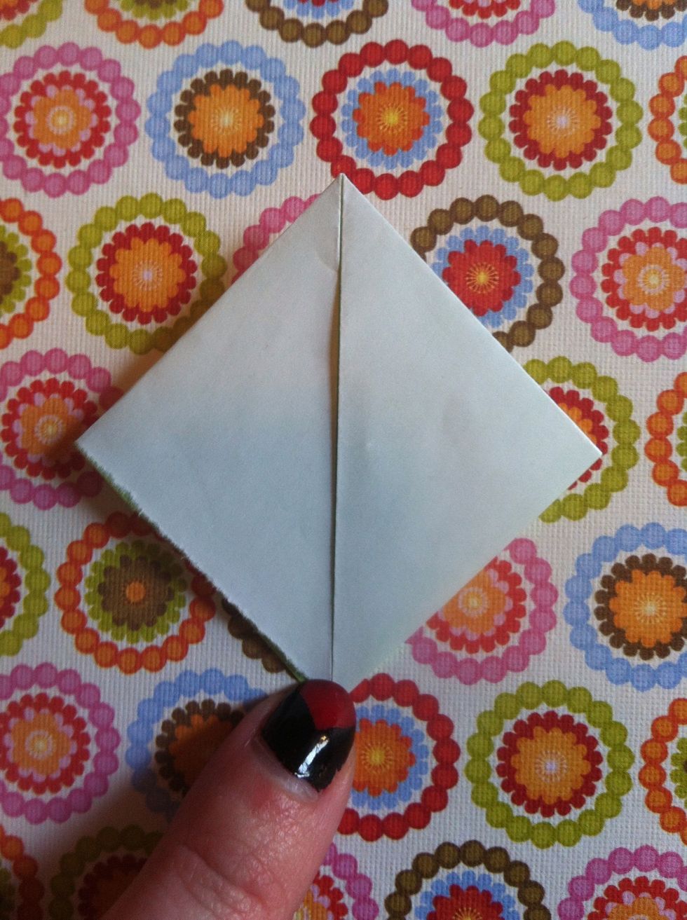 Fold left tip down to bottom point.