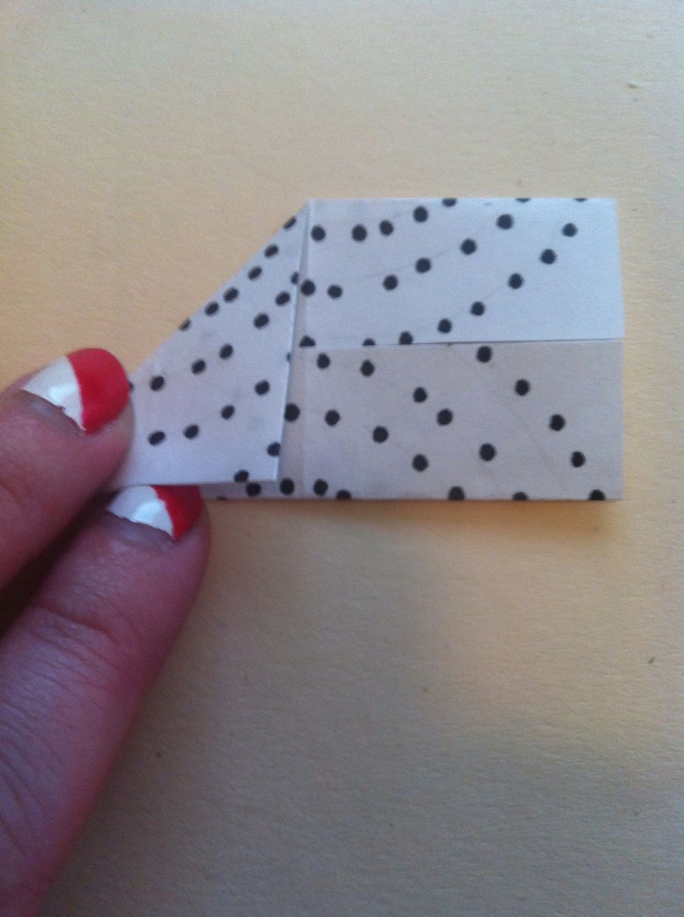 Fold left top corner down to bottom edge.
