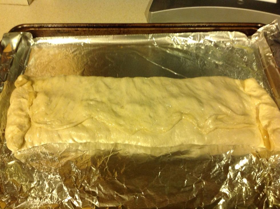 Fold long edges of dough on top of each other, and then seal the ends. Turn it on the cookie sheet so that the seam is facing down.