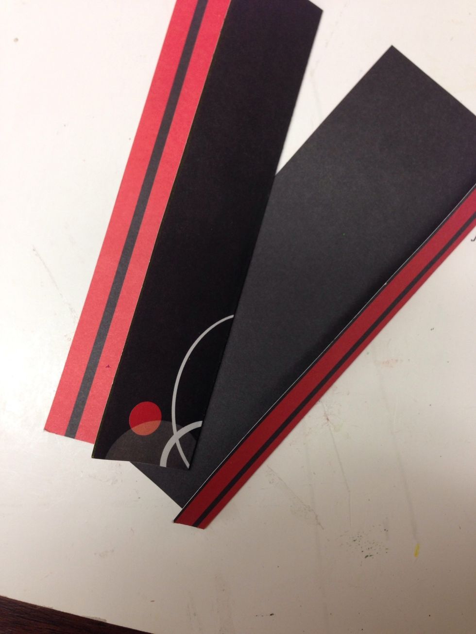 Fold on the crease lines, folding one flap to the front side of the paper and the other flap to the backside of the paper.