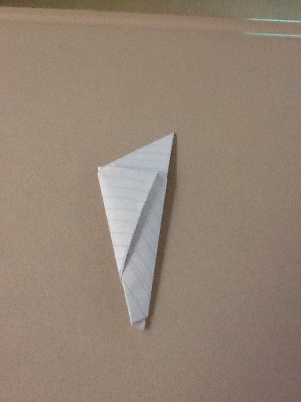 Fold once more and you'll see a hole to put the extra paper flap in