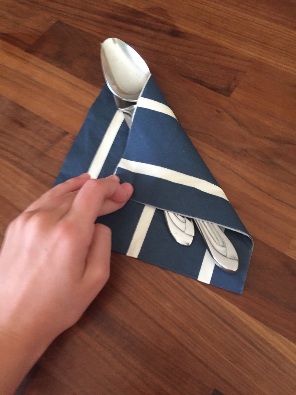 Fold one corner into a triangle across the silverware