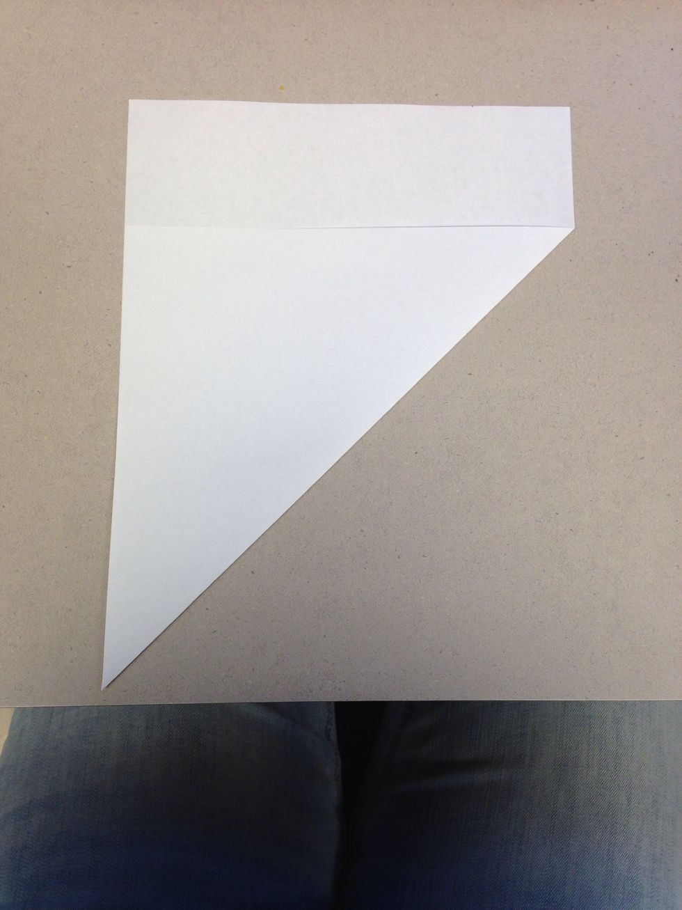 Fold one corner of a piece of the paper over to the adjacent side.