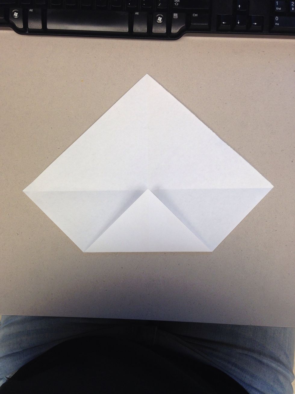 Fold one of the corners into the center point.