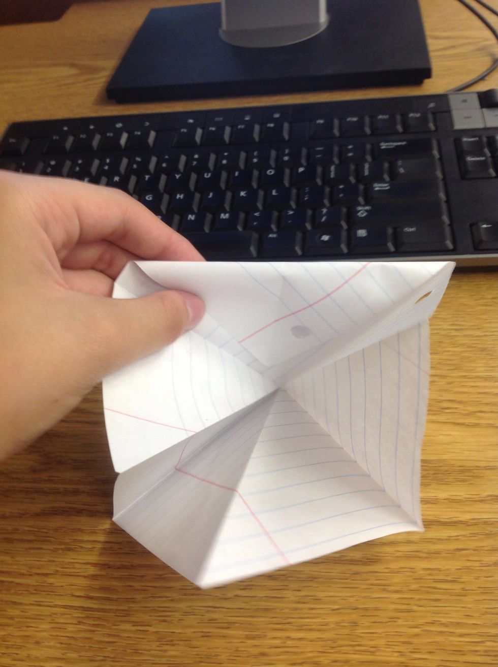 Fold one of the corners into the inside, to meet with the corner inside the square, and crease.