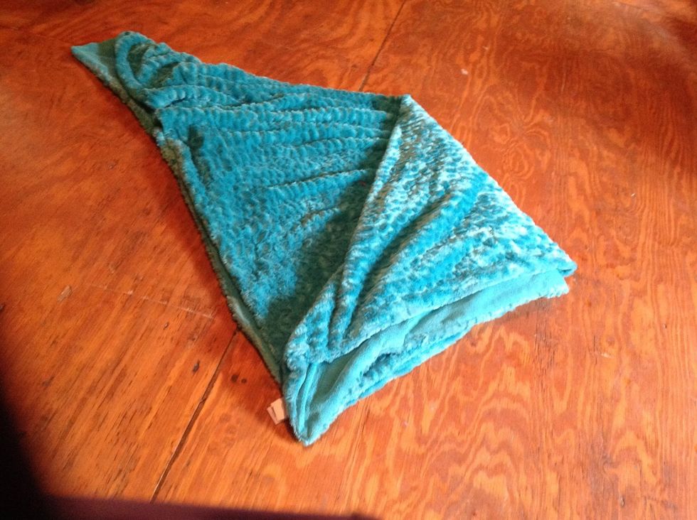 Fold one of the sides over on the corners you pulled together before.