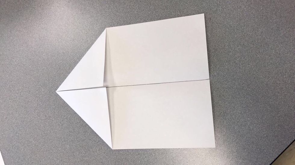 Fold other corner to half line.