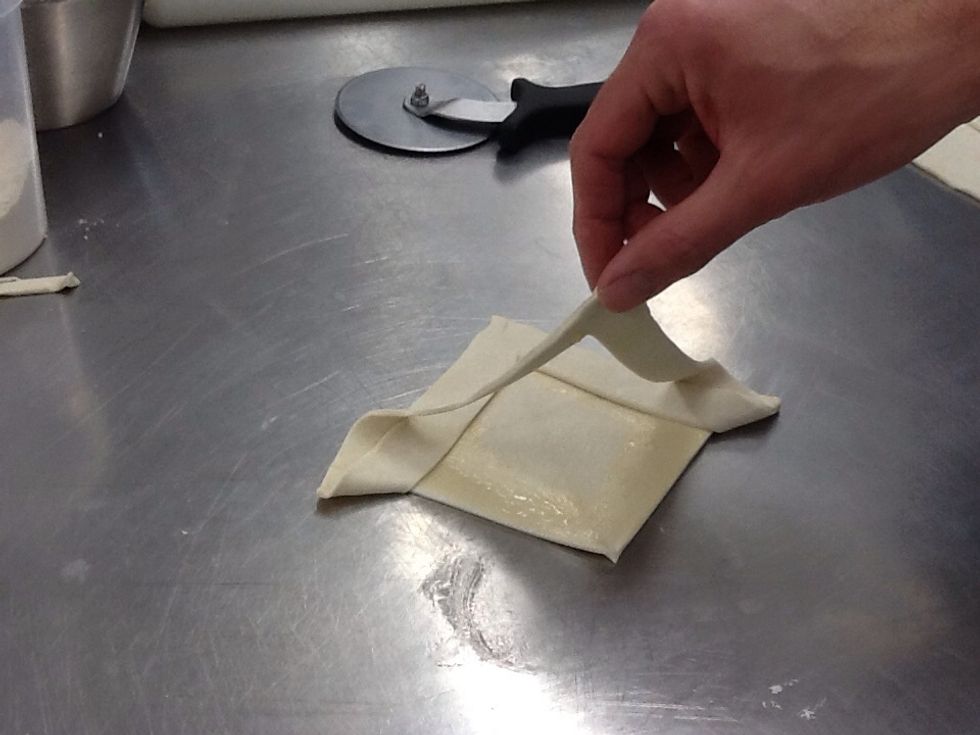 Fold other side over and place onto smaller square.