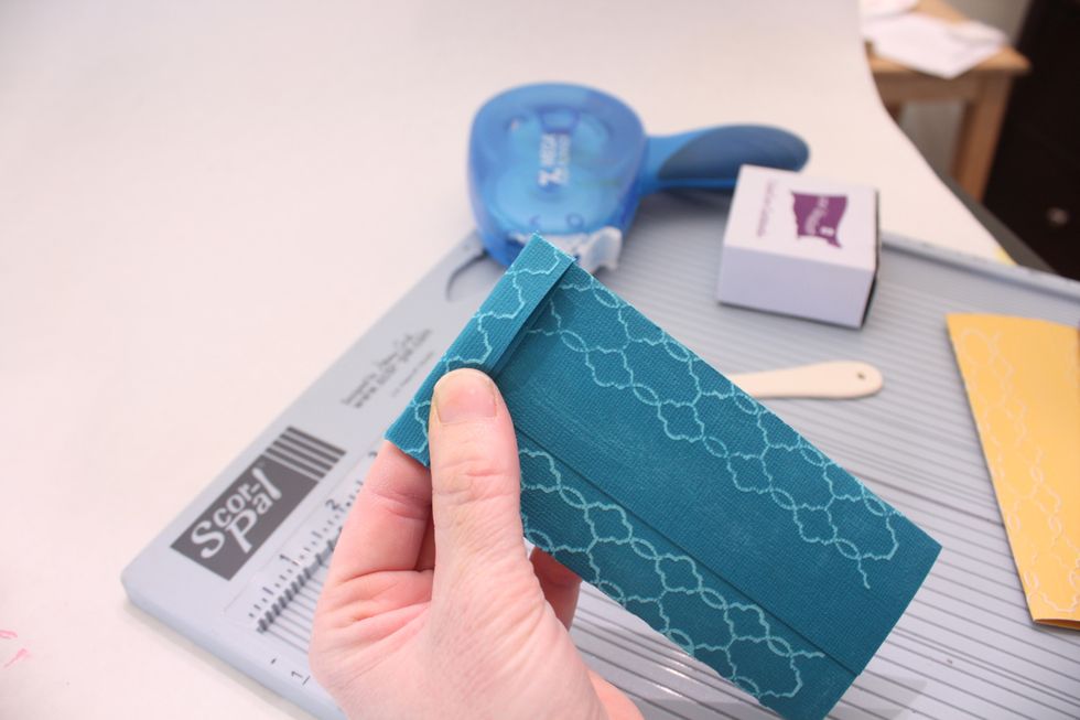 Fold over and attach with hot glue gun- tape runner will not be strong enough. You can use white glue too but you will have to use a paper clip to hold while it dries