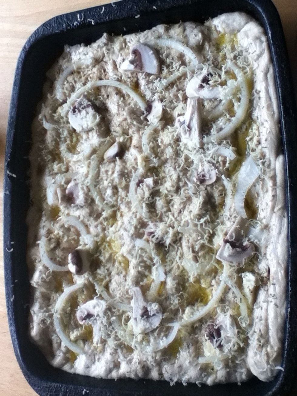 Fold over and top with onion half's, some chopped mushrooms, some mozzarella and the remaining oil and balsamic vinegar from the sweating process. grated a little extra cheese, ground sea salt on top