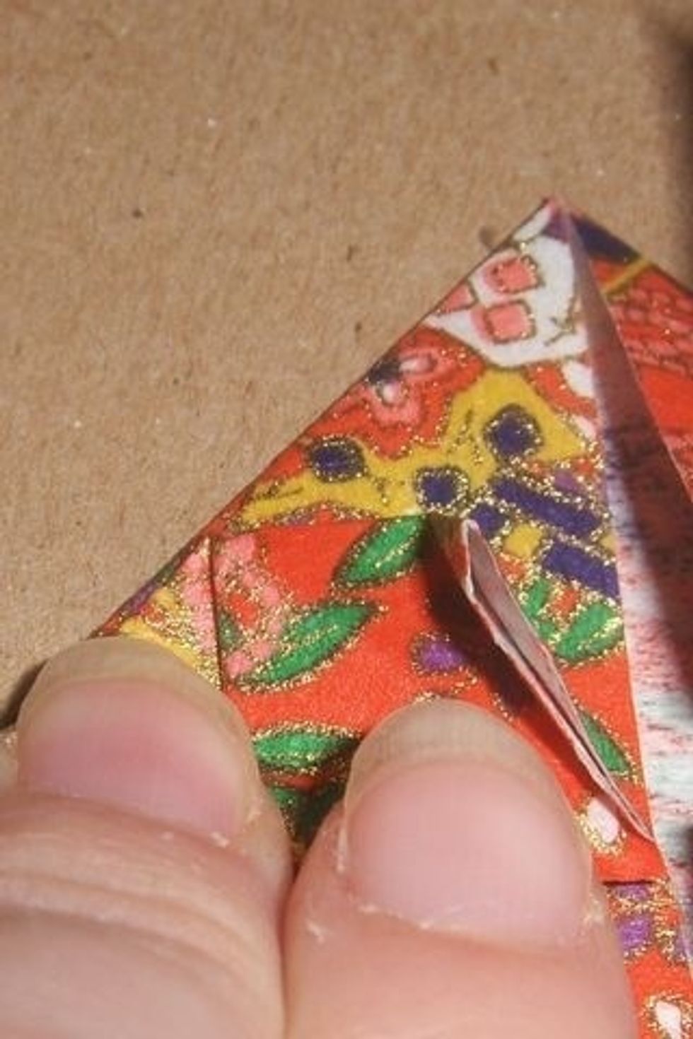 Fold over corner of the square you just made. Hope you have small fingers!