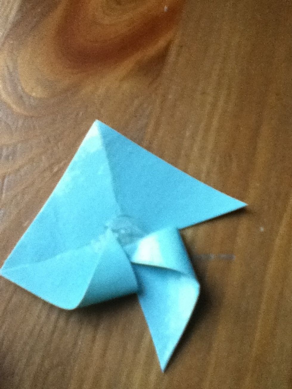 Fold over every right corner and stick to center.