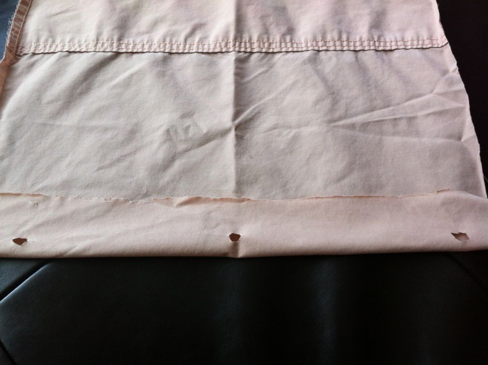 Fold over fabric and cut through folded part with scissors where you marked the holes. This will be the opening for the hooks.