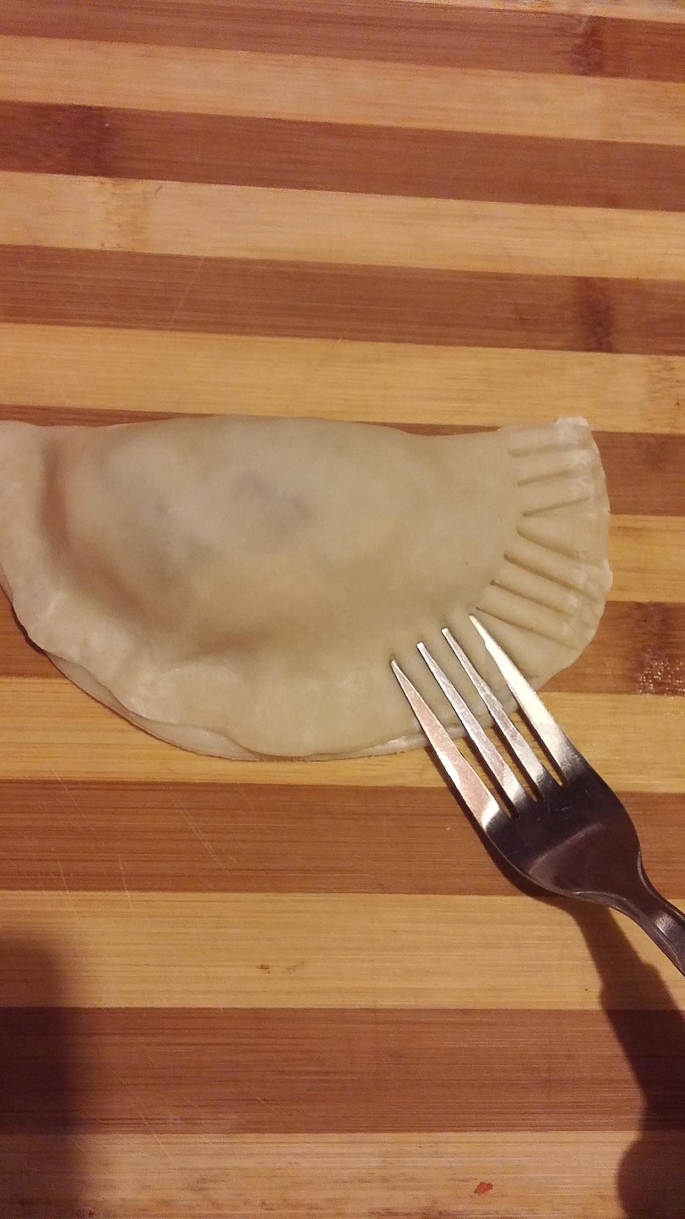 Fold over in half then gently push down onto the dough with a fork to seal the pastry