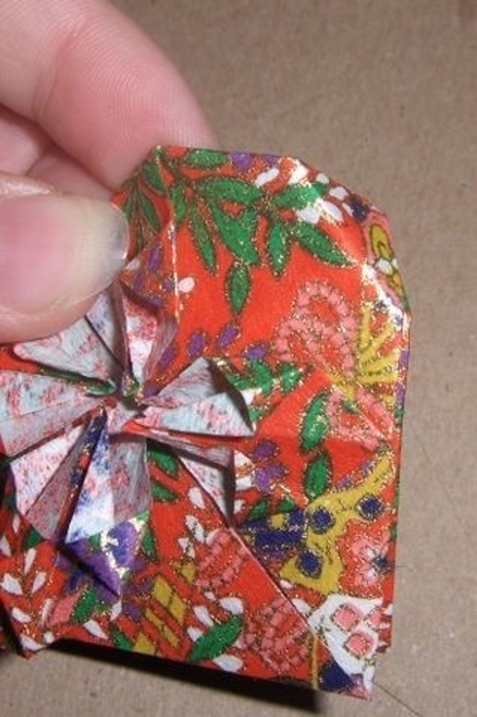 Fold over left and right corners to make desired heart shape.
