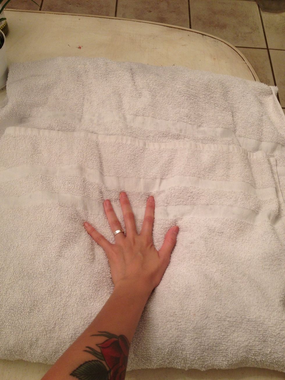 Fold over the ends of the towel and gently press to blot excess water.