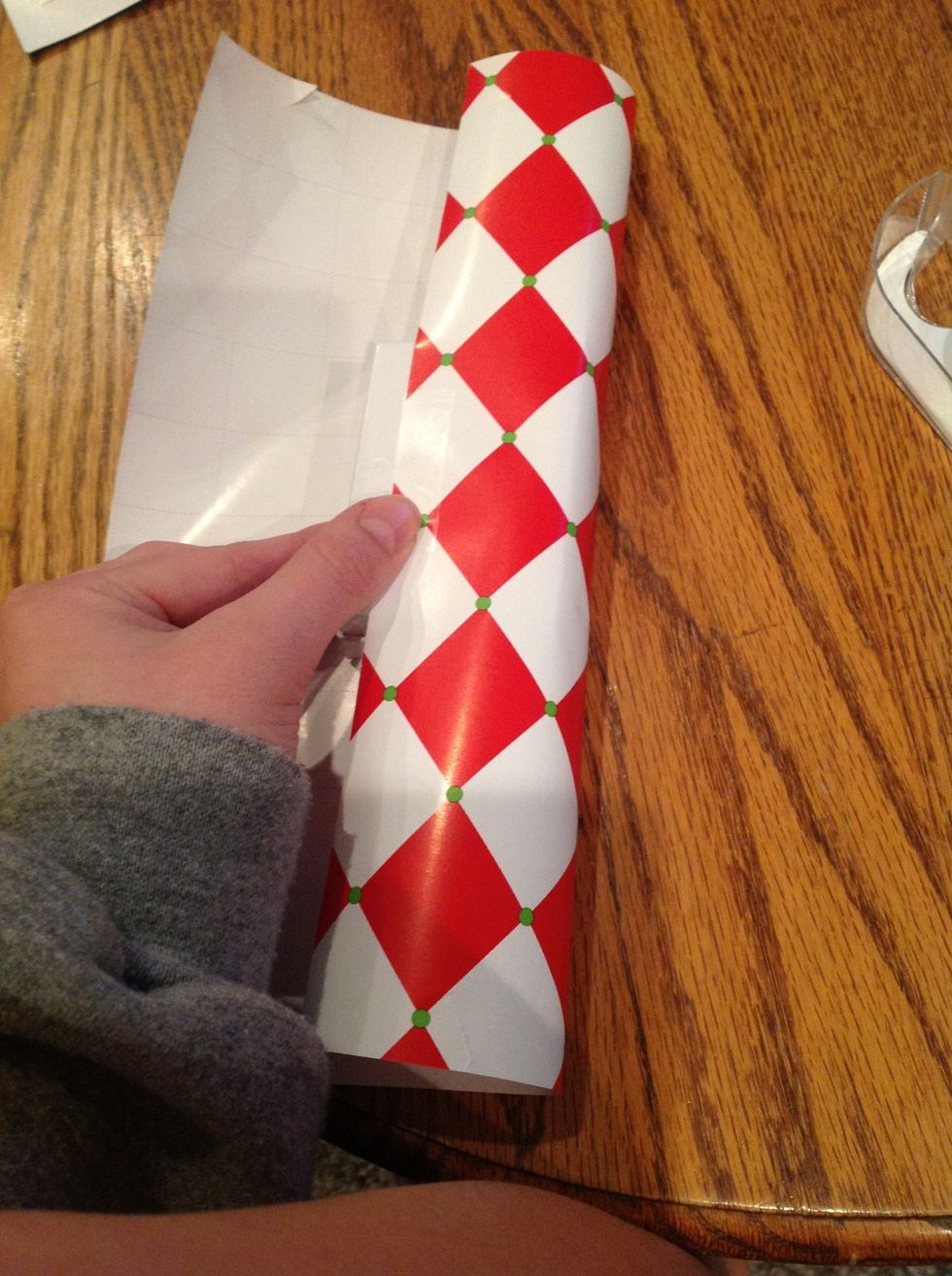 fold over the first edge so that it is about in the center of the present and tape it down