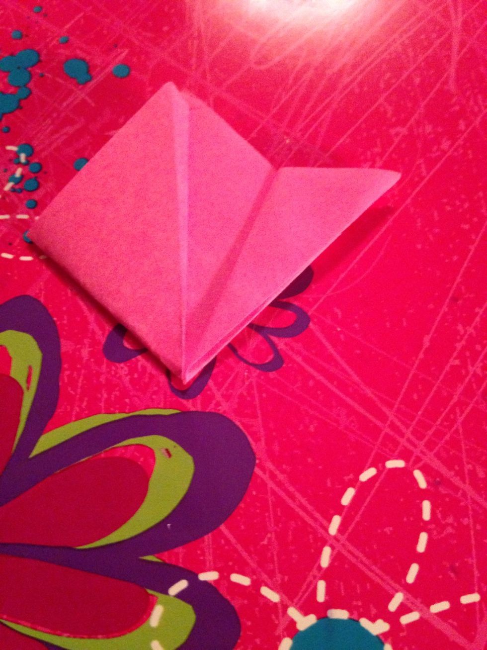 Fold over the right crease to line up with one of the bottom flowers
