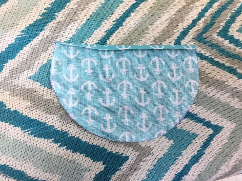 Fold over the same side (the flat side) 1/4" again to create a double turn. There will no longer be raw edges showing along the top of the pocket piece.