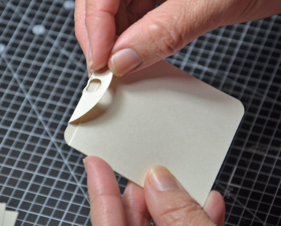 Fold over the top of the word tag as shown. This will be how we stop the tag from pulling entirely out of the inside of the card.